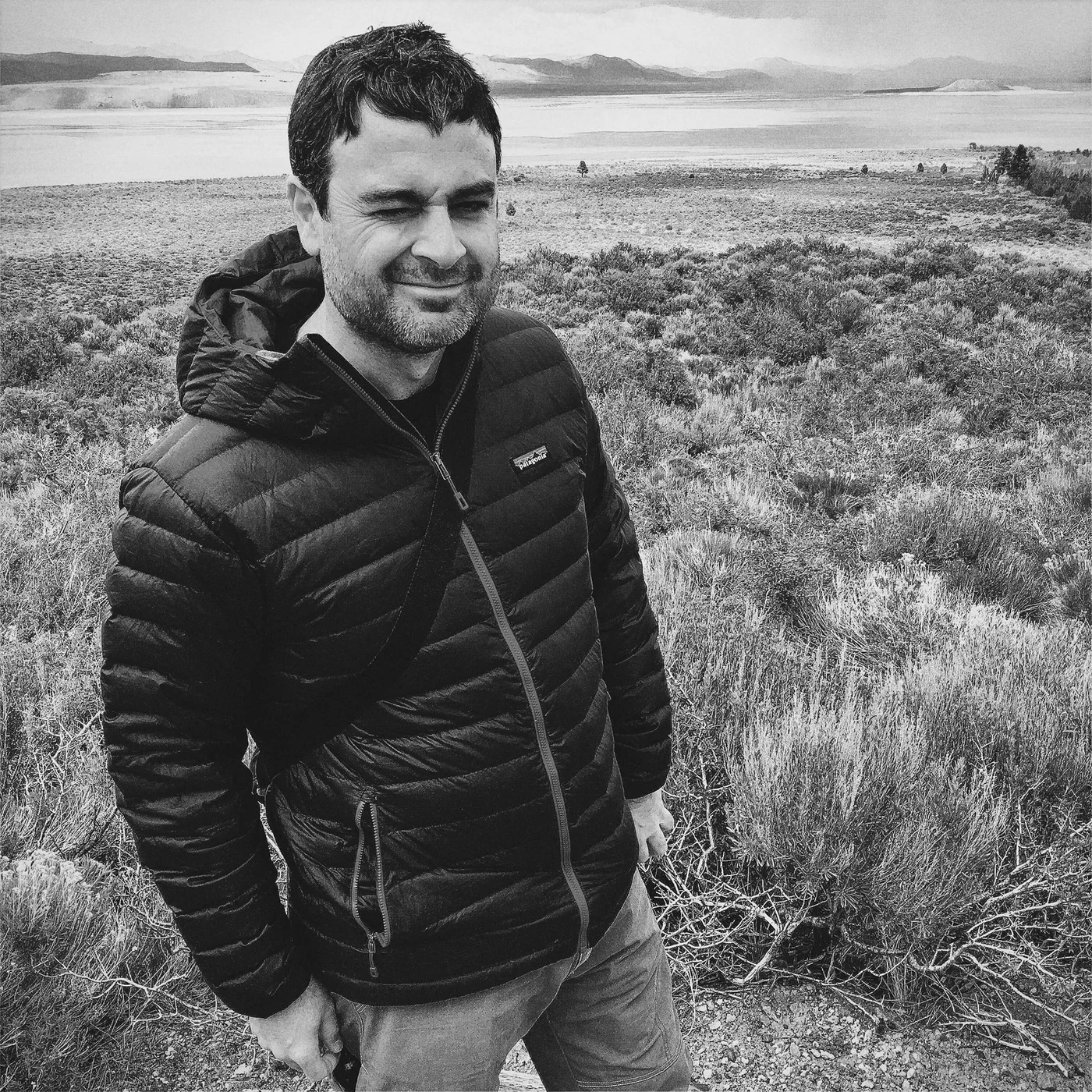 Dave Baiocchi outdoors in the high desert, wearing a puffy winter coat.